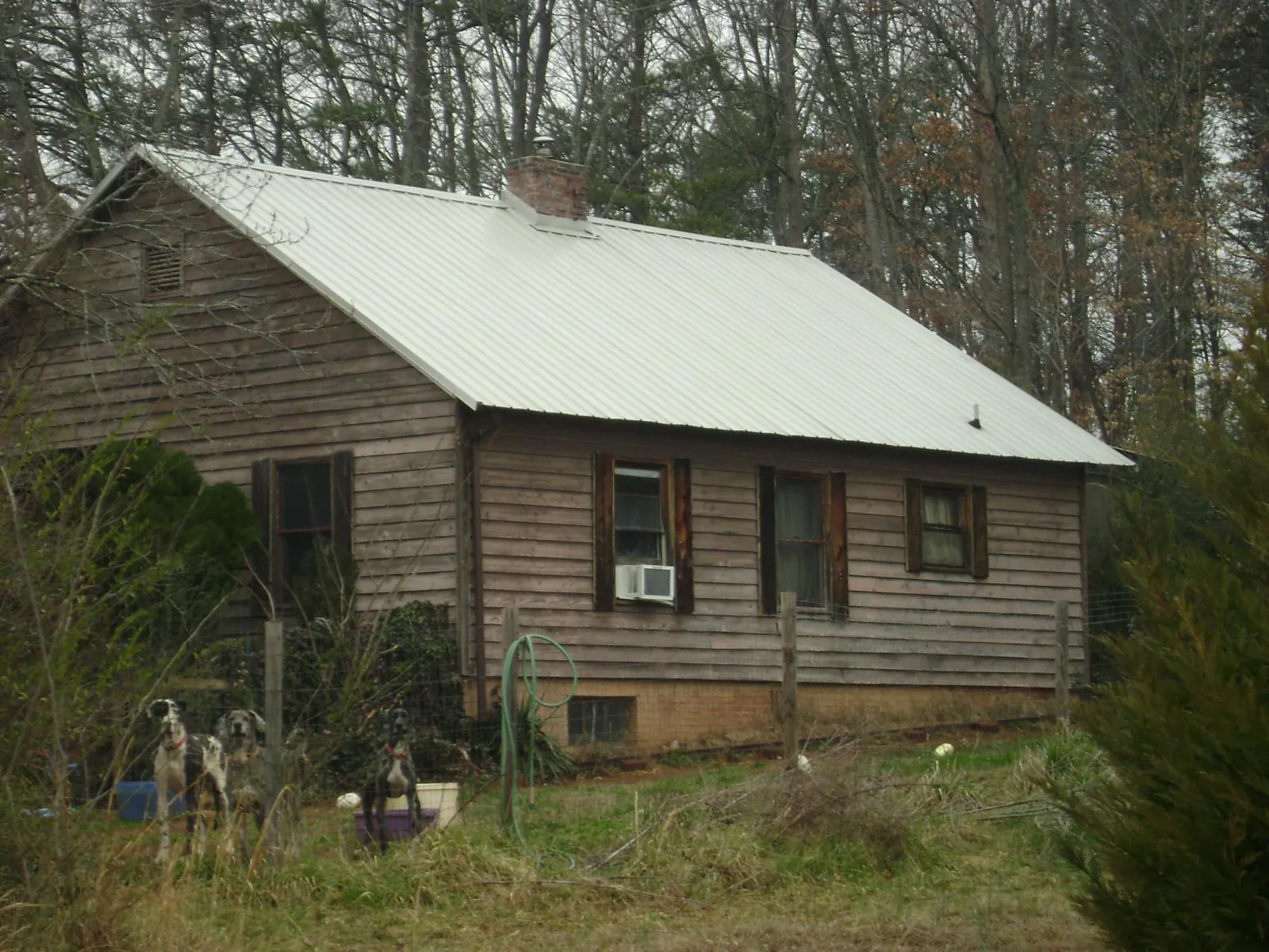 White metal roof on an old wood sided farmhouse, from a Metal Roof Installation job in Lake Wilson
